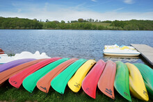Colorful Kayaks Canoes Along A Lake