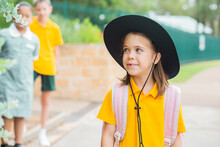 Little Girl With Unsure Expression On Face Saying Goodbye To Mum At School Gate