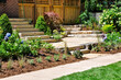 Huge natural stone slab flagstone steps create beautiful landscaping and a transition to a hidden garden in this front yard no grass urban garden.