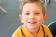 © Nicole Hastings/Austockphoto - Young boy in school uniform smiling up at camera