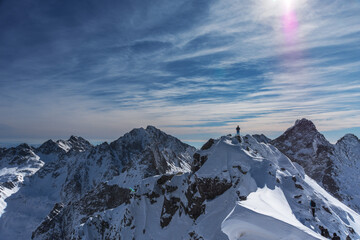 Wall Mural - Beautiful winter views of the High Tatra Mountains with tourists, skiers and amazing states of nature