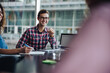 © Jacob Lund - Smiling young man sitting in boardroom meeting