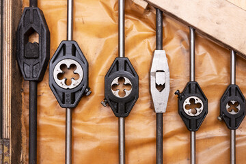 Various thread cutters on oil paper in a wooden box