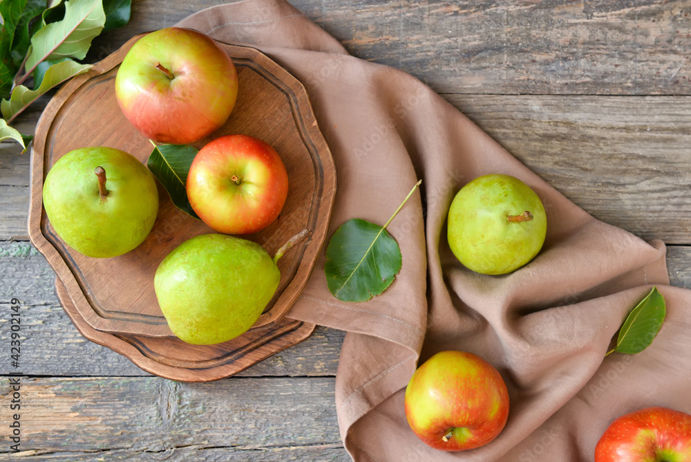 Tasty apple and pear fruits on wooden background