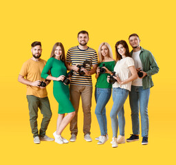  Group of young photographers on color background