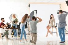 Young Photographers Taking Picture Of Woman In Studio
