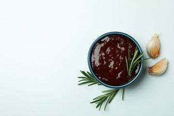 Barbecue sauce, rosemary and garlic on white background