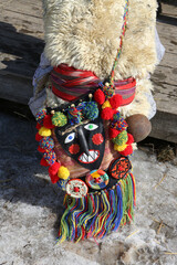 Wall Mural - Moscow Maslenitsa Festival. Traditional national celebration in russian folk style. Slavic tradition. Performance with artists in Moscow city, Russia. Detail of ethnic costume. Ornamental bohemian bag