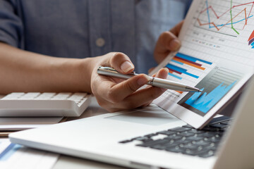 Businesswoman hands hold documents with financial statistic stock photo,discussion and analysis data the charts and graphs. Finance concept