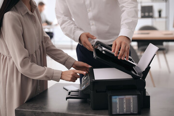 Wall Mural - Employees using modern printer in office, closeup