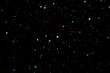 © Victoria - Shiny multicolored glitters scattered in space on black background