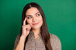 © deagreez - Photo of minded smart lady look empty space finger temple wear plaid shirt isolated green color background