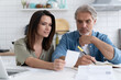 © opolja - Stressed family couple received debt mortgage notification, checking financial documents