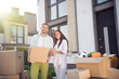 © deagreez - Photo of optimistic couple remove with boxes wear casual cloth near home outdoors