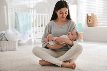 Sticker - Young woman with her cute baby at home