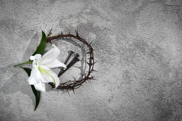 Wall Mural - Good Friday, Passion of Jesus Christ. Crown of thorns, nails and white lily on grey background. Christian Easter holiday.