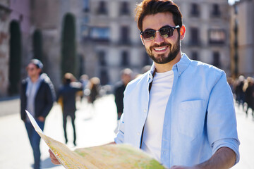 Wall Mural - Happy man navigating with map