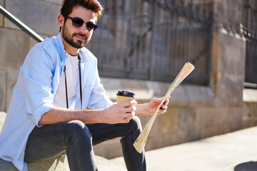 Wall Mural - Trendy bearded traveler  chilling and drinking coffee