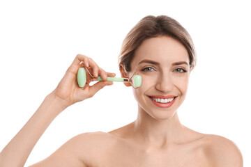 Poster - Young woman using natural jade face roller on white background