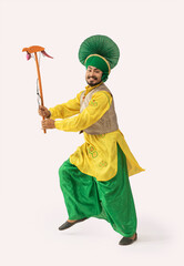 Wall Mural - A Bhangra Dancer performing with a Kato.	