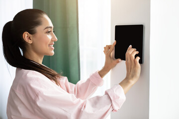 Aufkleber - Woman using smart wall home control system