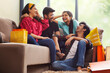 © IndiaPix - A Group of youngsters talking happily in living room after a shopping spree.
