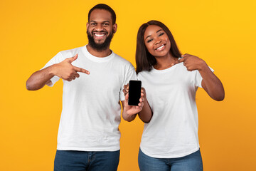 Wall Mural - Black couple showing blank empty smartphone screen for mockup