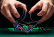 Close-up hands of a person-dealer or croupier shuffling poker cards in a casino on the background of a table, chips. Poker game or gaming business concept