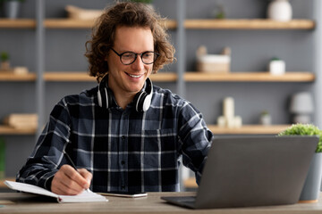 Poster - Young Businessman At Laptop Taking Notes Working In Modern Office
