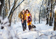 © Maksim Selin - Young couple smiling and having fun in winter park with their husky dog