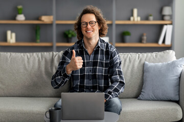 Poster - Happy Freelancer Guy At Laptop Gesturing Thumbs-Up Sitting At Home