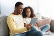 © Prostock-studio - Happy black dad and daughter using digital tablet