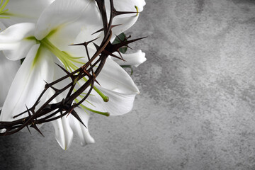 good friday, passion of jesus christ. crown of thorns, nails and white lily on grey background. chri