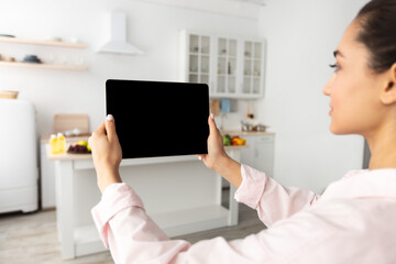 Poster - Woman using digital tablet with blank empty screen, mockup