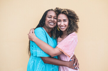 Wall Mural - Portrait of cheerful african mother and adult daughter together - Family, mother and child love