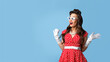 © Prostock-studio - Unbelievable news. Excited pin up woman in cool retro dress expressing her shock on blue background, free space
