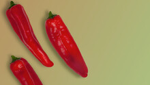 Fresh Red Long Sweet Pointed Peppers On Color Background.
