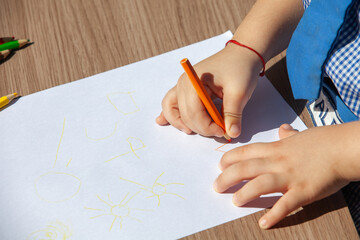 children's hands with a pencil