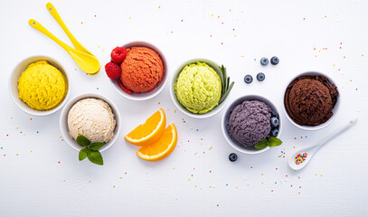 Leinwandbilder - Various of ice cream flavor ball blueberry ,lime ,pistachio ,almond ,orange ,chocolate and vanilla set up on white wooden background . Summer and Sweet menu concept.