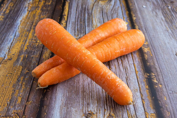 Fresh carrot on a wooden background