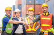 © JU.STOCKER - Happiness engineer and worker team group joining hands at cargo containers. Success Teamwork Concepts