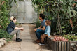 © Елена Григорович - Adventurous family inspecting tropical gallery in Botanical garden. Local travel