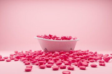 Wall Mural - Red hearts falling on Bathtub on pink background. 3D Render minimal idea concept.