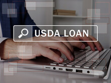  USDA LOAN United States Department Of Agriculture Inscription On The Screen. Close Up Merchant Hands Holding Black Smart Phone.