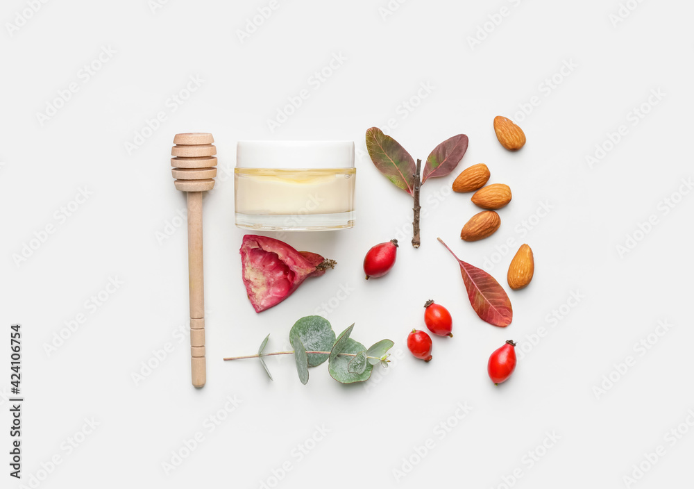 Composition with jar of natural cream on white background