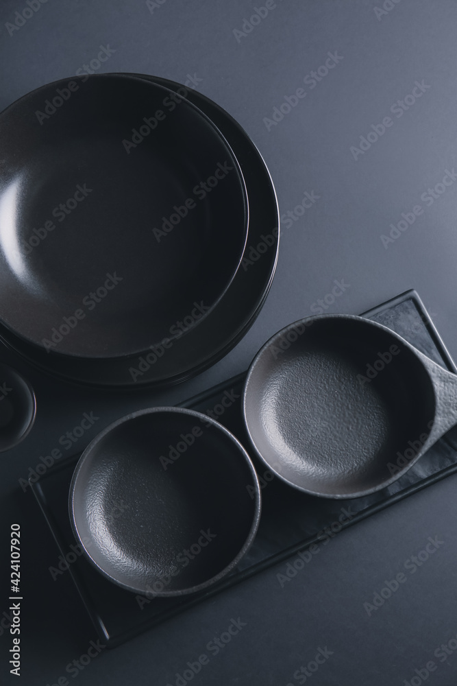 Stylish tableware on dark background