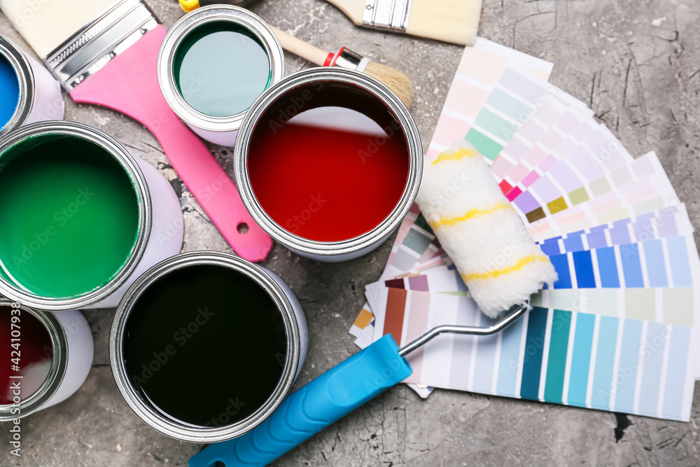 Cans of paints and tools on grunge background