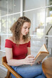 © Charlie's - Beautiful girl.  smiling woman reading a book at home Study Concept reading book