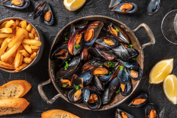 Wall Mural - Mussels with potatoes, lemons, and toasted bread, top shot