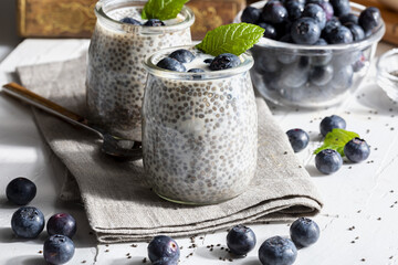 Appetizing, healthy and refreshing chia seed pudding with fresh blueberries and mint leaves. Vegetarian and vegan food with healthy superfoods. Homemade look.